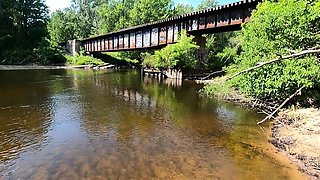 Big-Titted Brunette Gives Public Blowjob by the River!