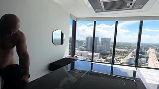 In a kitchen a sexy brunette playing with her big boobs