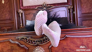 The Goddess in white fishnet tights foot teasing on the bed