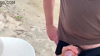 Milf holds my penis tightly in her hand until I cum right on the beach
