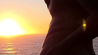 Buxom babe shows off sexy body in nude poses at sunset