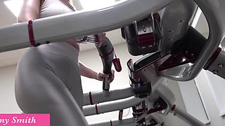 Athletic milf with big tits exposes her rack while working out in gym