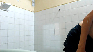 This girl is undressing to take a bath