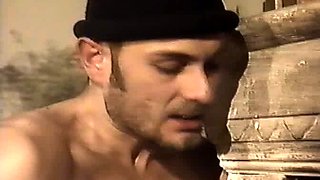 In a kitchen a sexy brunette playing with her big boobs