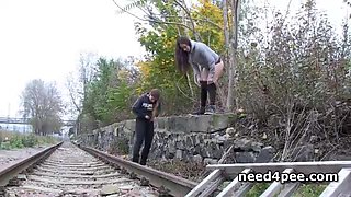 Teen girlfriends urinating on the railway