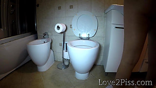 Peeing in a tall lavatory and wiping her pussy