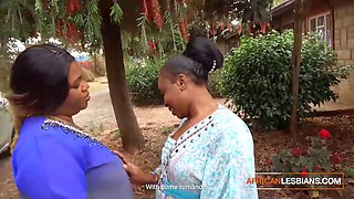 Big-Titted African Lesbians Kiss in Public at House Party