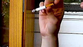 Shaved Head Goth Smokes Outside