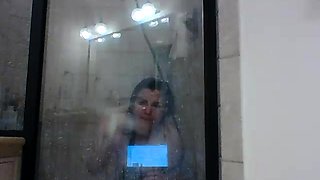 Chubby brunette girl pleases her aching cunt in the shower