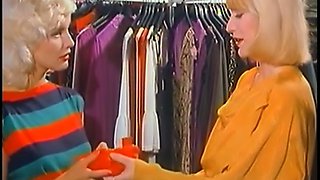 Two playful and joyful blonde ladies eat each other in the dressing room